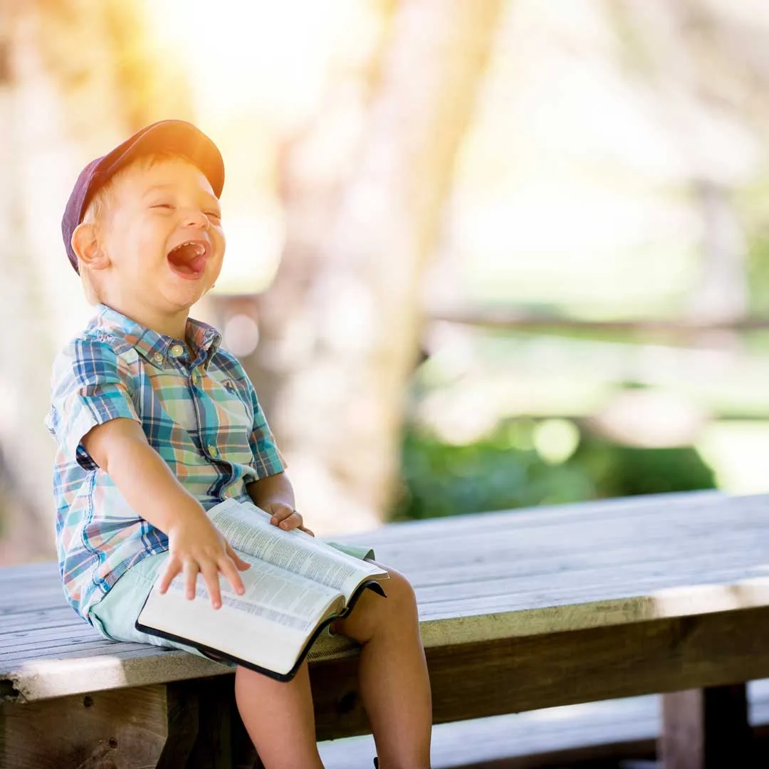 A young disabled child with an open book.