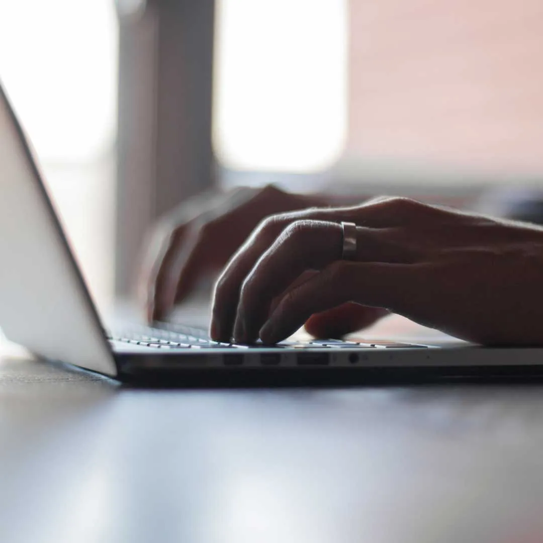 Someone typing on a laptop